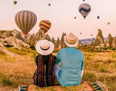 Couple looking up a hot air ballons